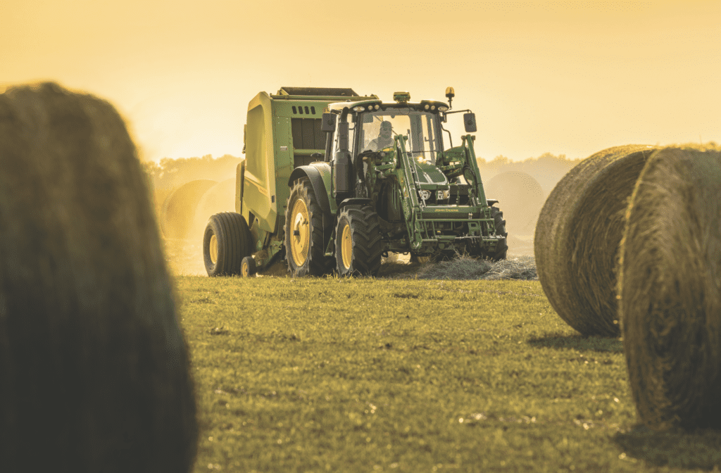 Tractor with hay baler attachment